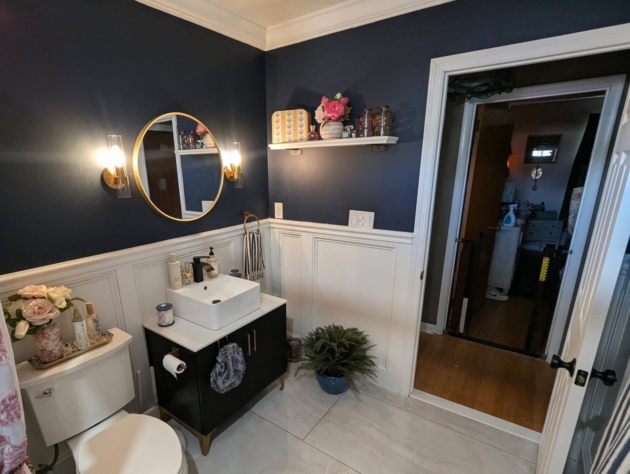 Finished bathroom vanity lighting and wainscoting